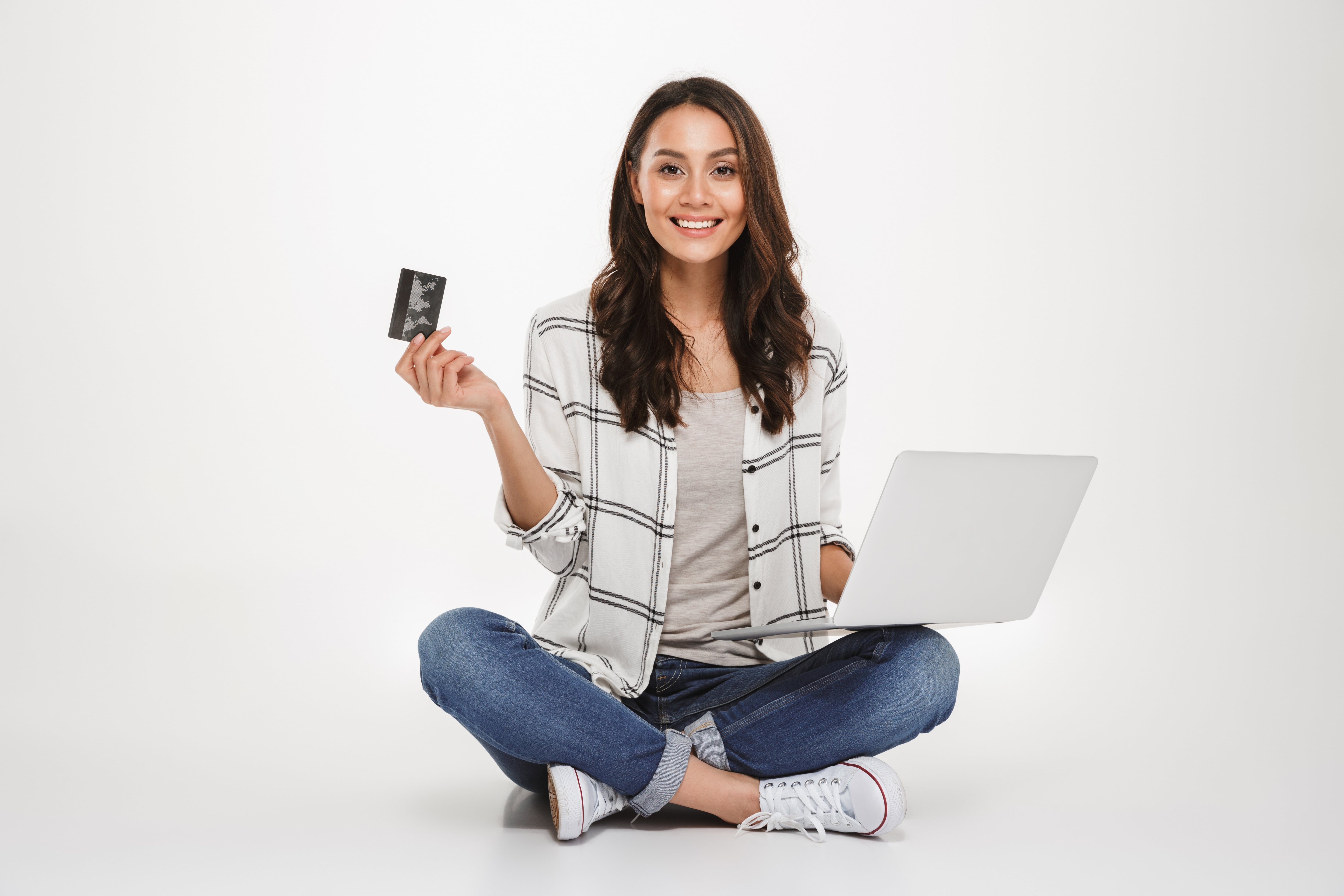 smiling woman sitting on the floor with laptop